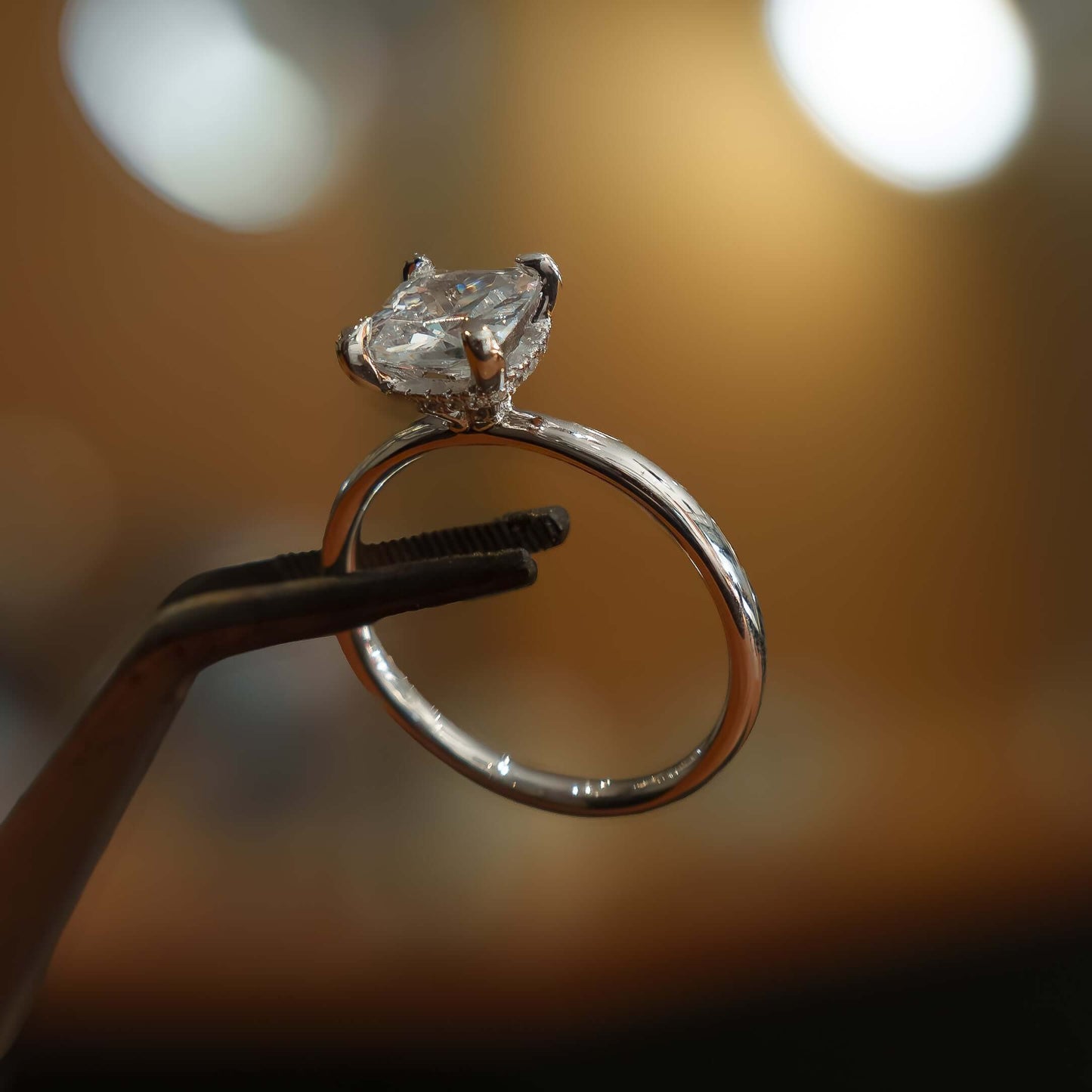 studio image of luxury cushion platinum hidden halo solitaire lab grown diamond engagement ring