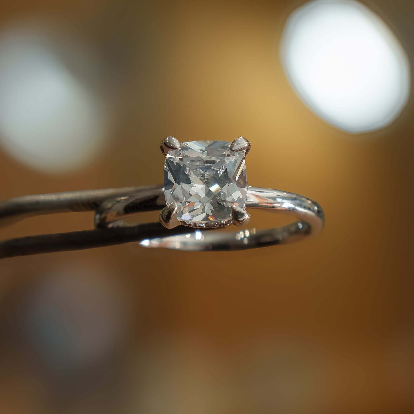studio image of luxury cushion white gold hidden halo solitaire lab grown diamond engagement ring