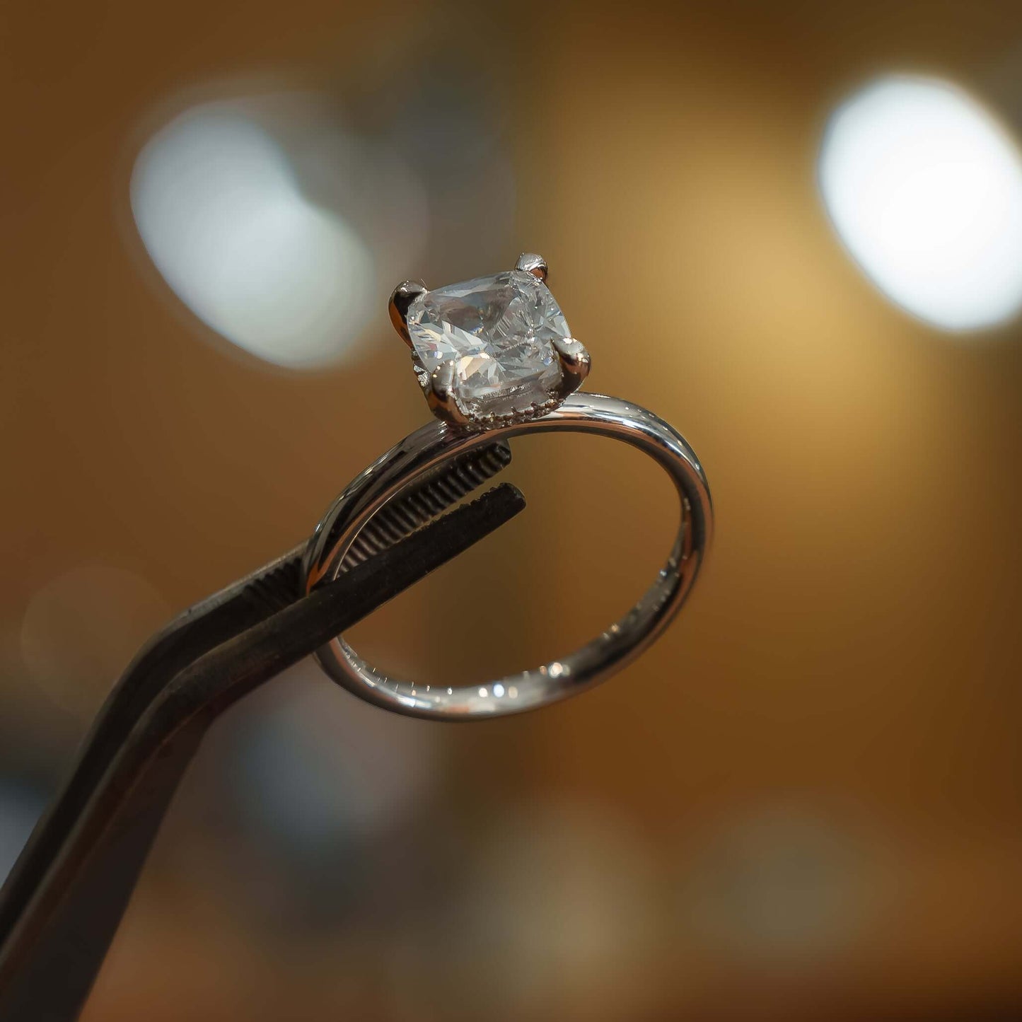 studio image of luxury cushion platinum hidden halo solitaire lab grown diamond engagement ring