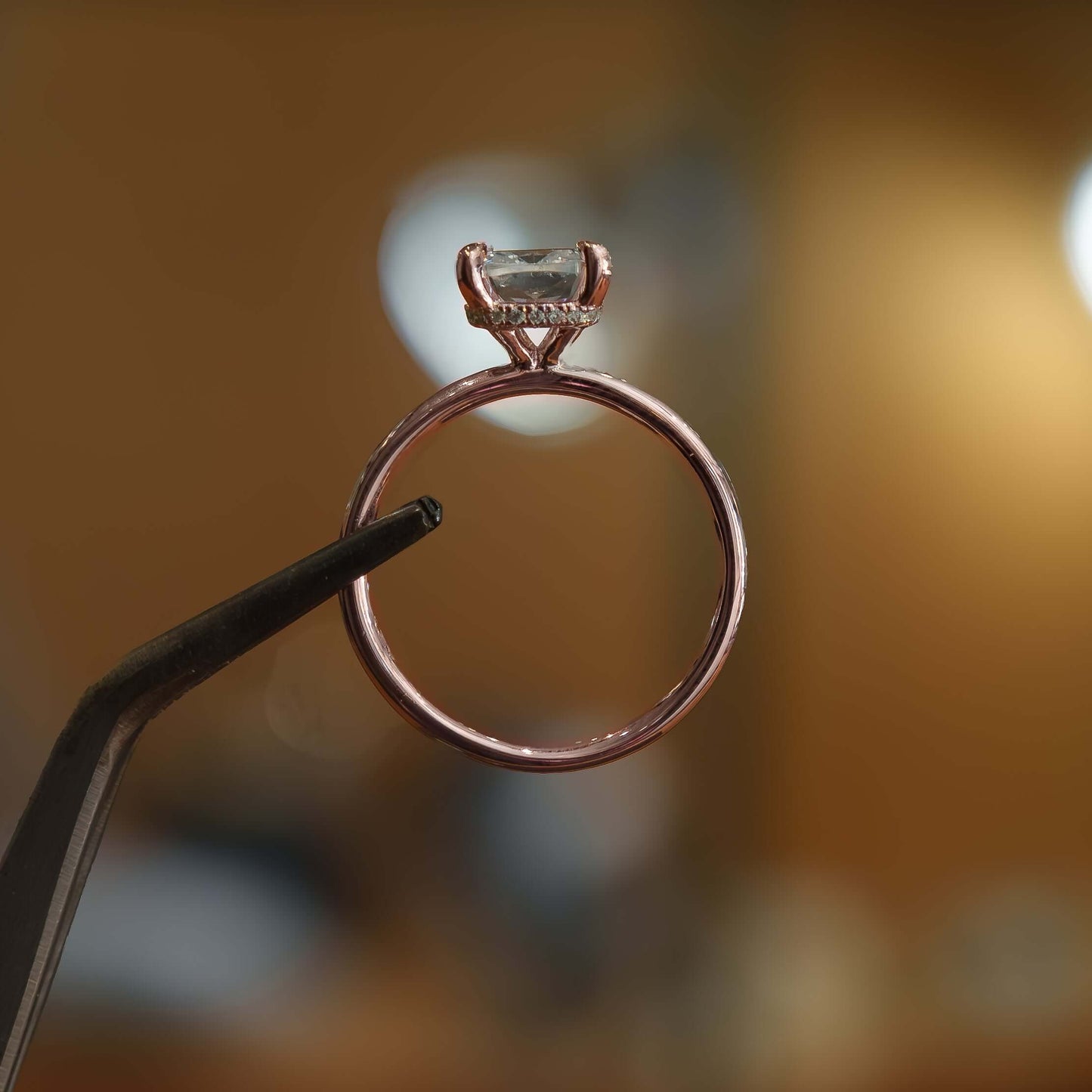 luxury cushion rose gold hidden halo solitaire lab grown diamond engagement ring in studio 