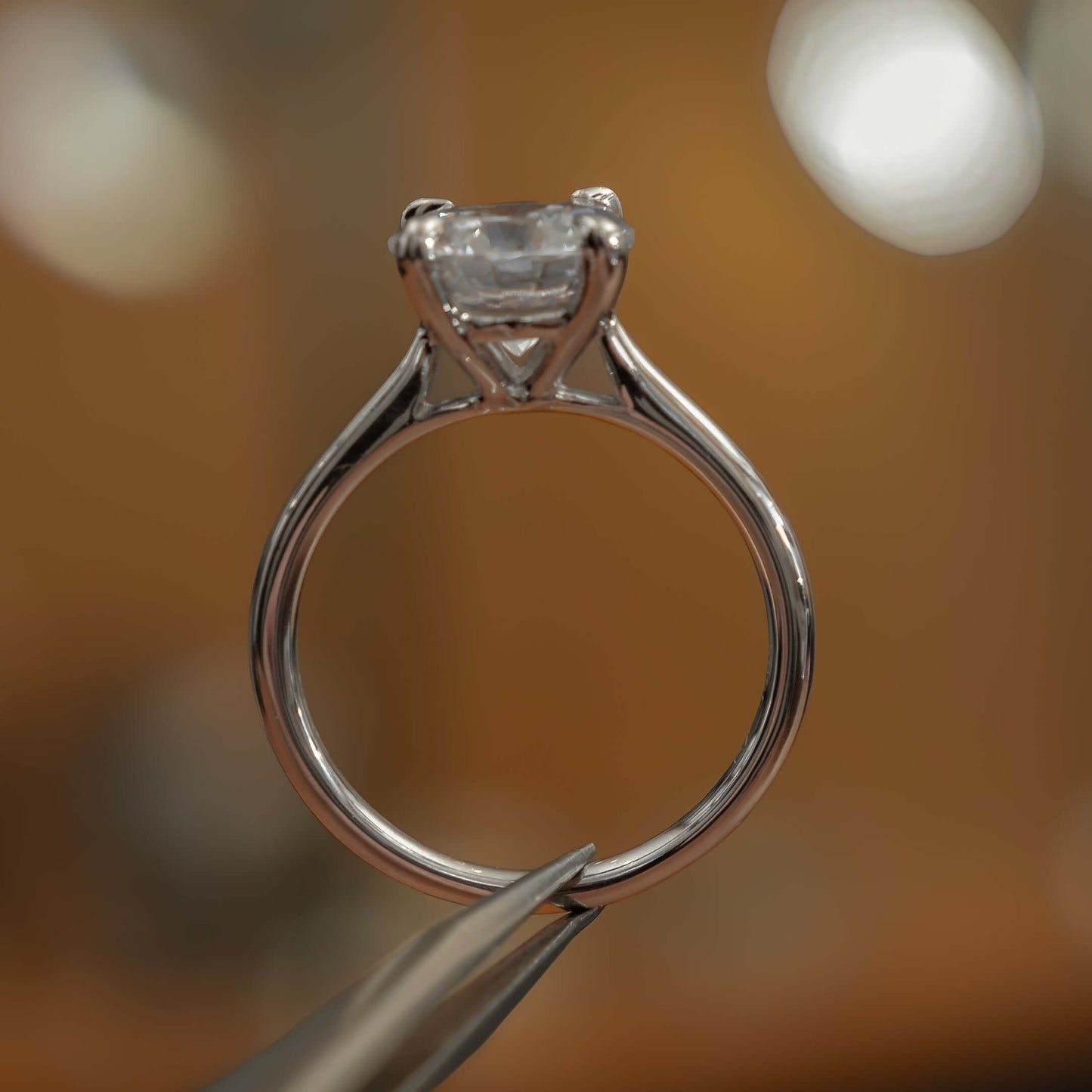 side view luxury platinum solitaire round lab grown diamond engagement ring in studio