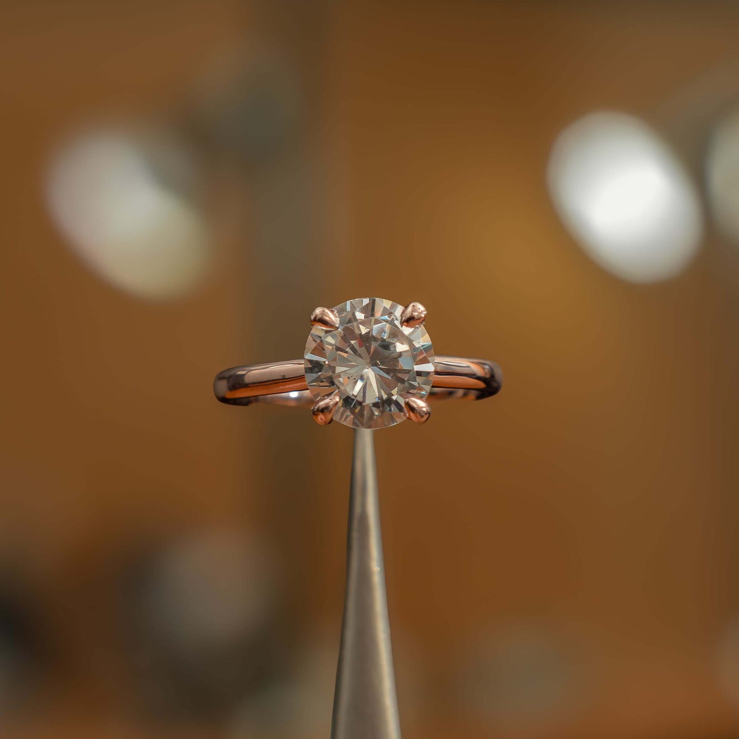 frontal image of luxury round rose gold solitaire lab grown diamond engagement ring