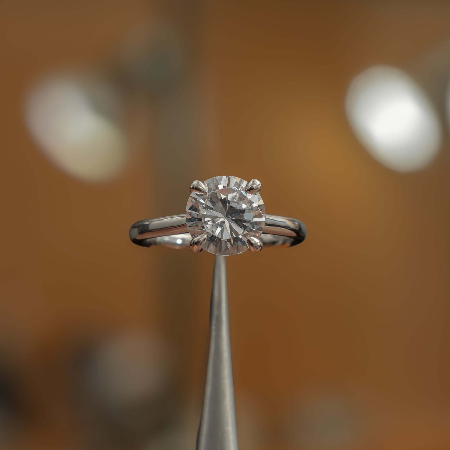 frontal view luxury platinum solitaire round lab grown diamond engagement ring in studio