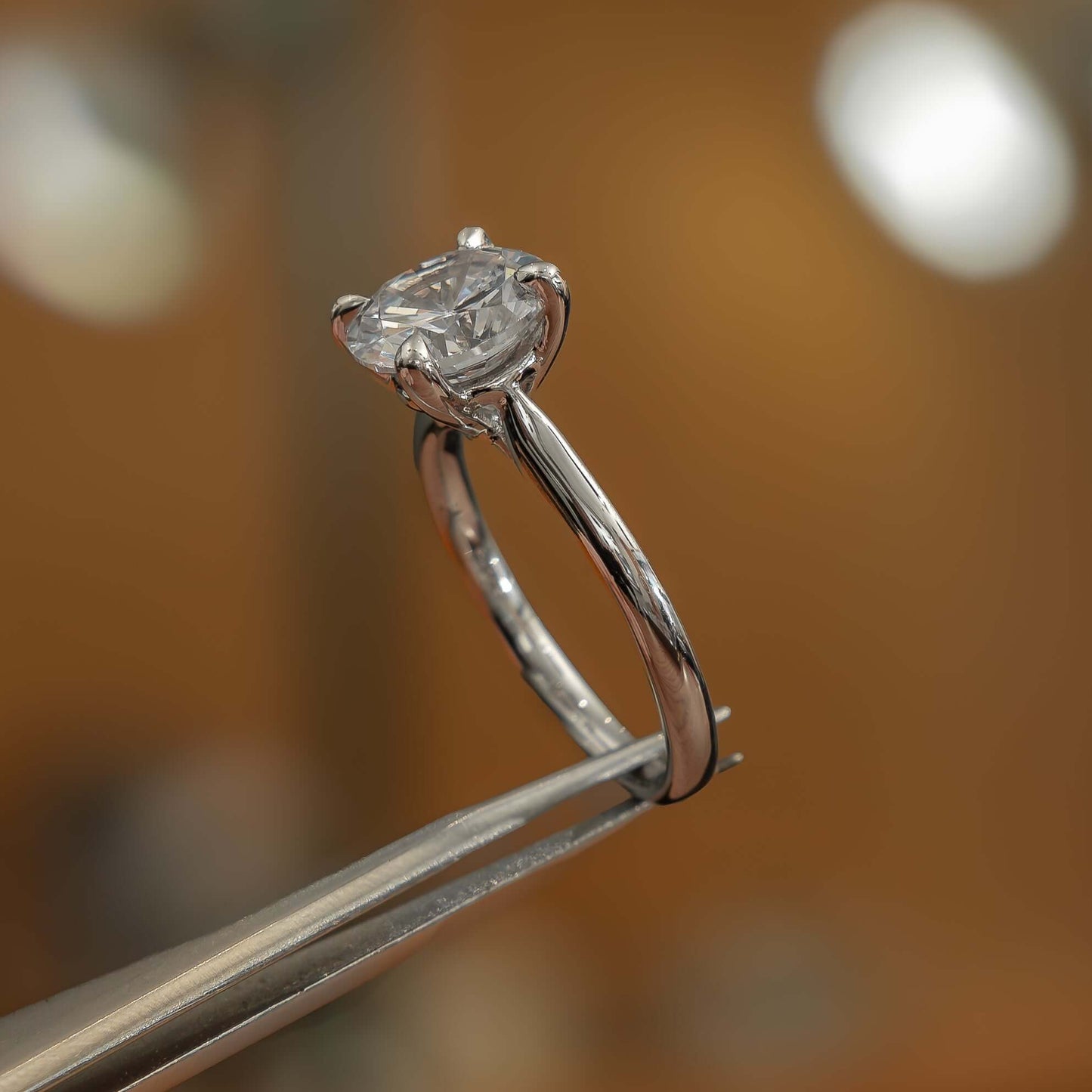 side image of luxury platinum solitaire round lab grown diamond engagement ring in studio