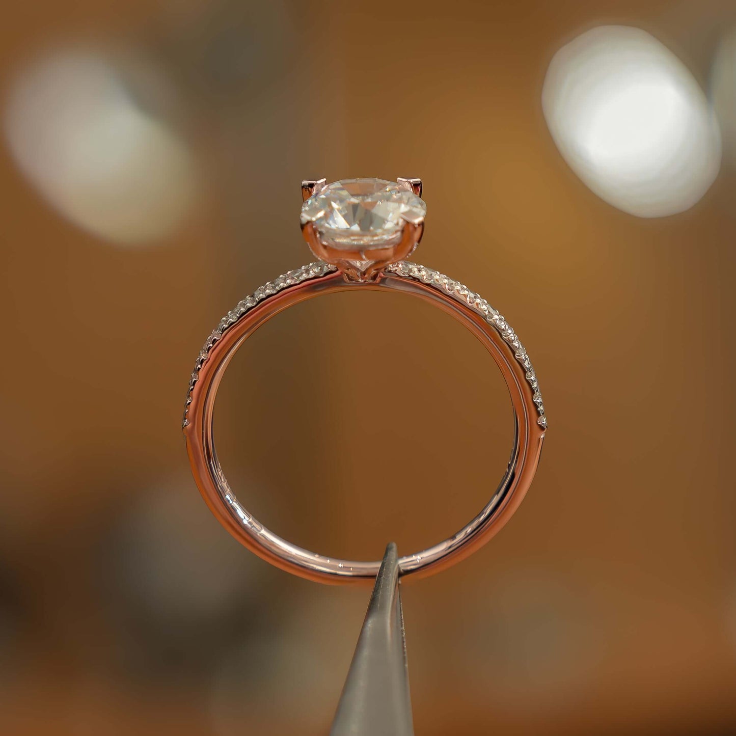 side image of luxury round rose gold diamond set shoulders lab grown diamond engagement ring