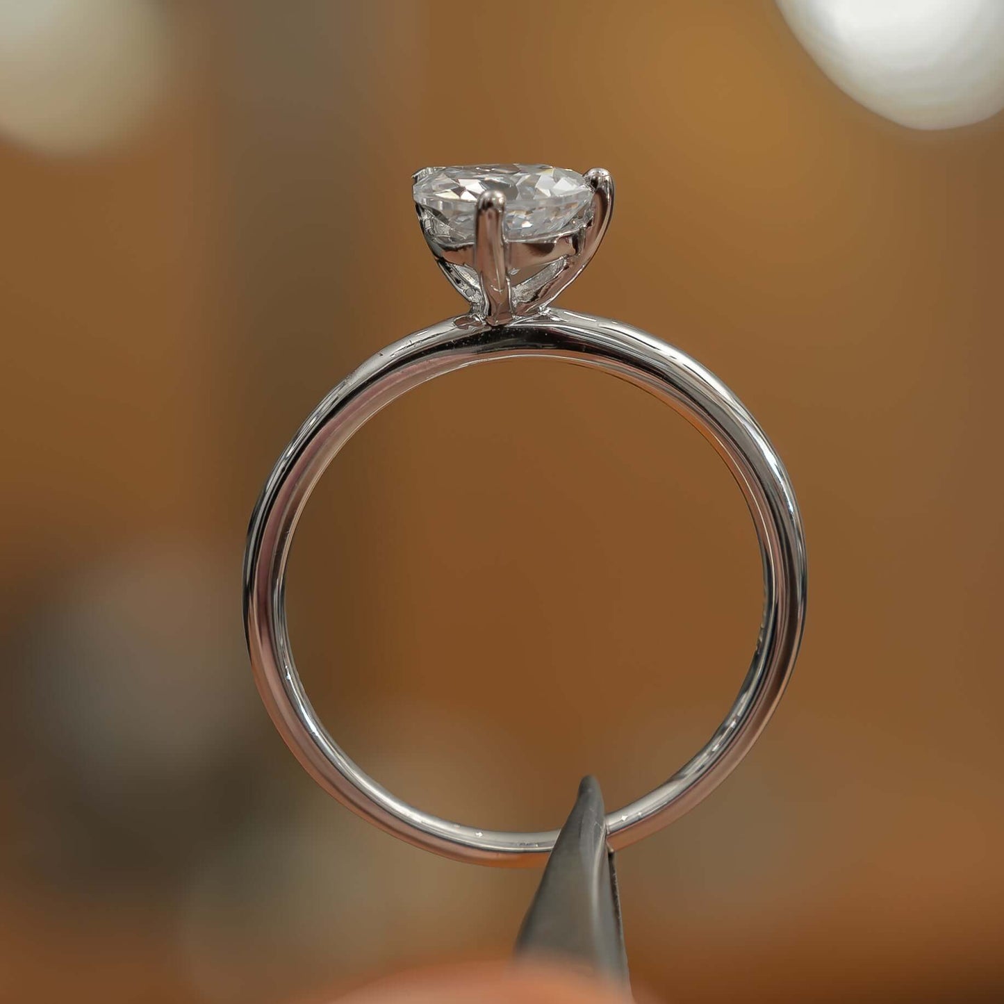 side angle in studio luxury pear white gold solitaire lab grown diamond engagement ring