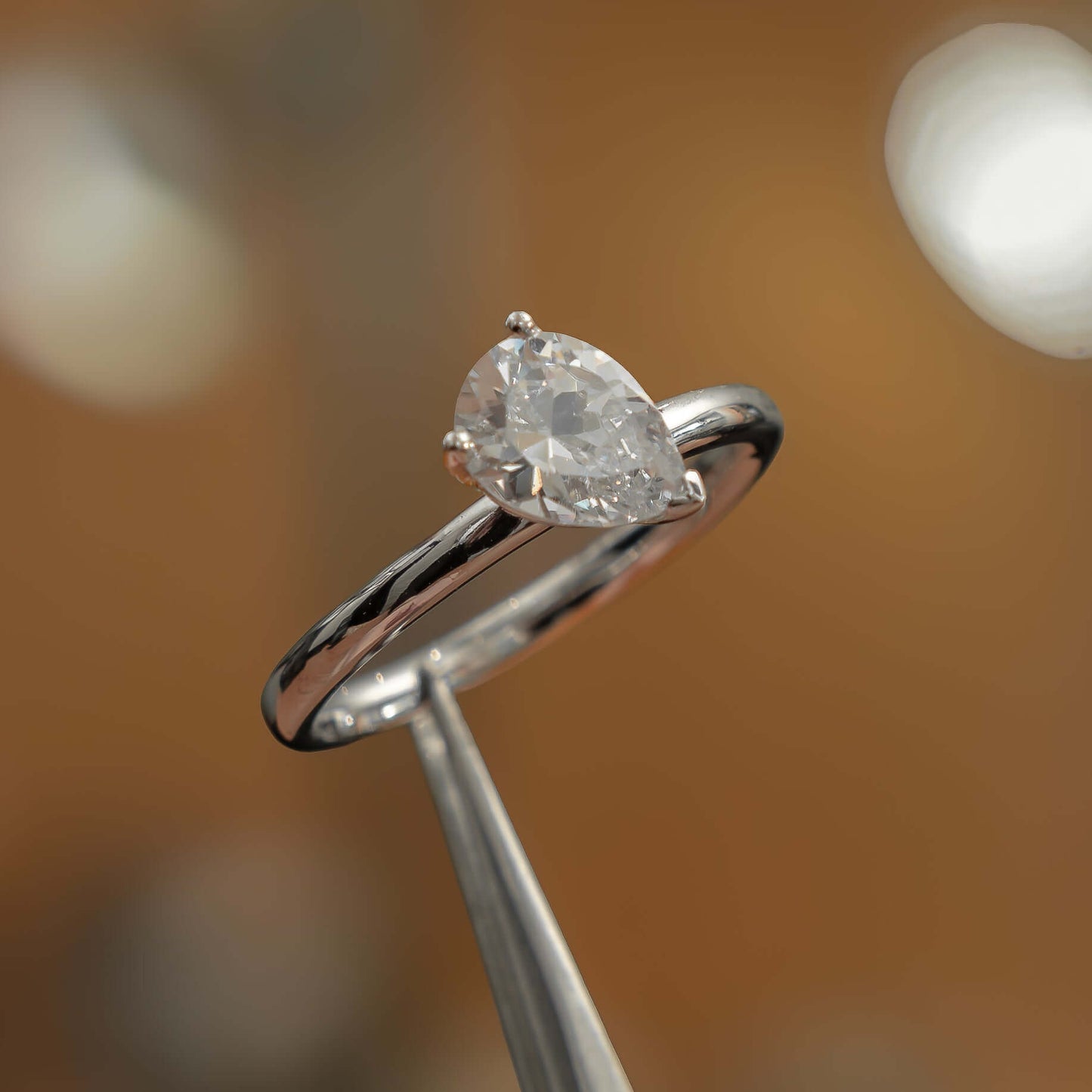 side angle in studio luxury pear white gold solitaire lab grown diamond engagement ring