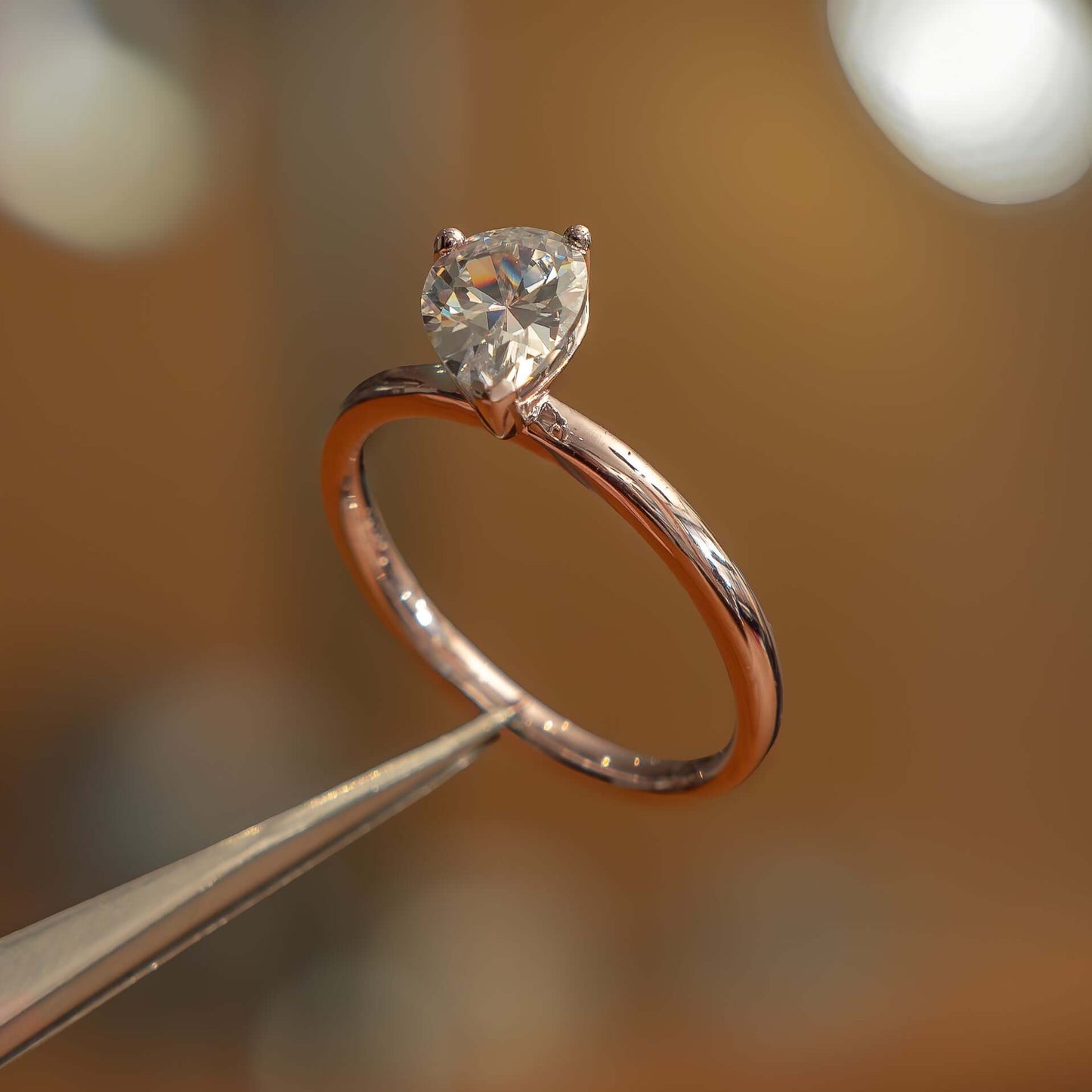 side angle in studio luxury pear rose gold solitaire lab grown diamond engagement ring