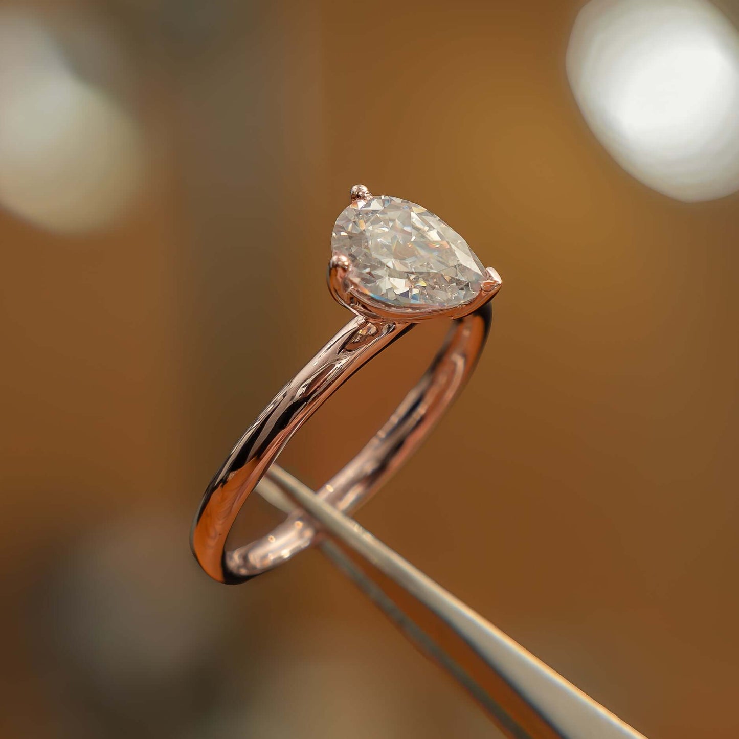 side angle in studio luxury pear rose gold solitaire lab grown diamond engagement ring