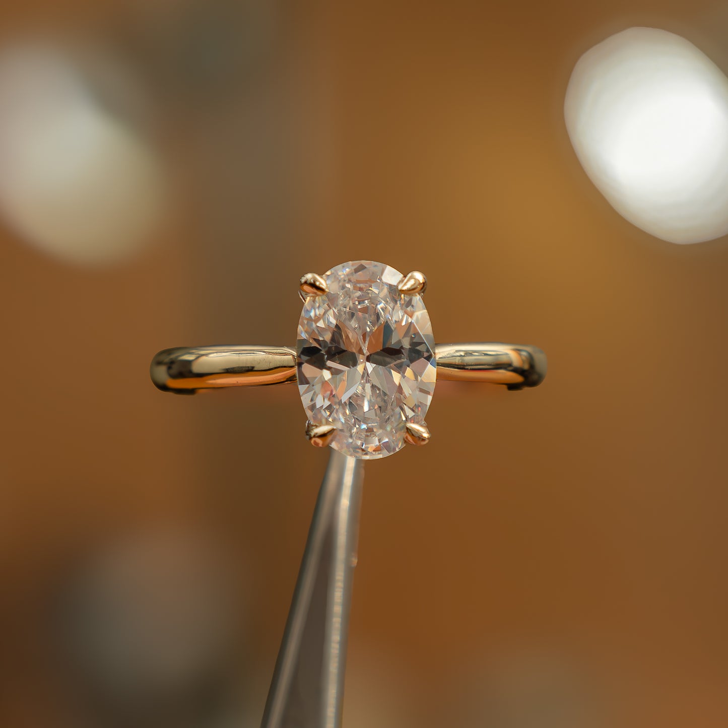 frontal view luxury oval yellow gold solitaire lab grown diamond engagement ring in studio
