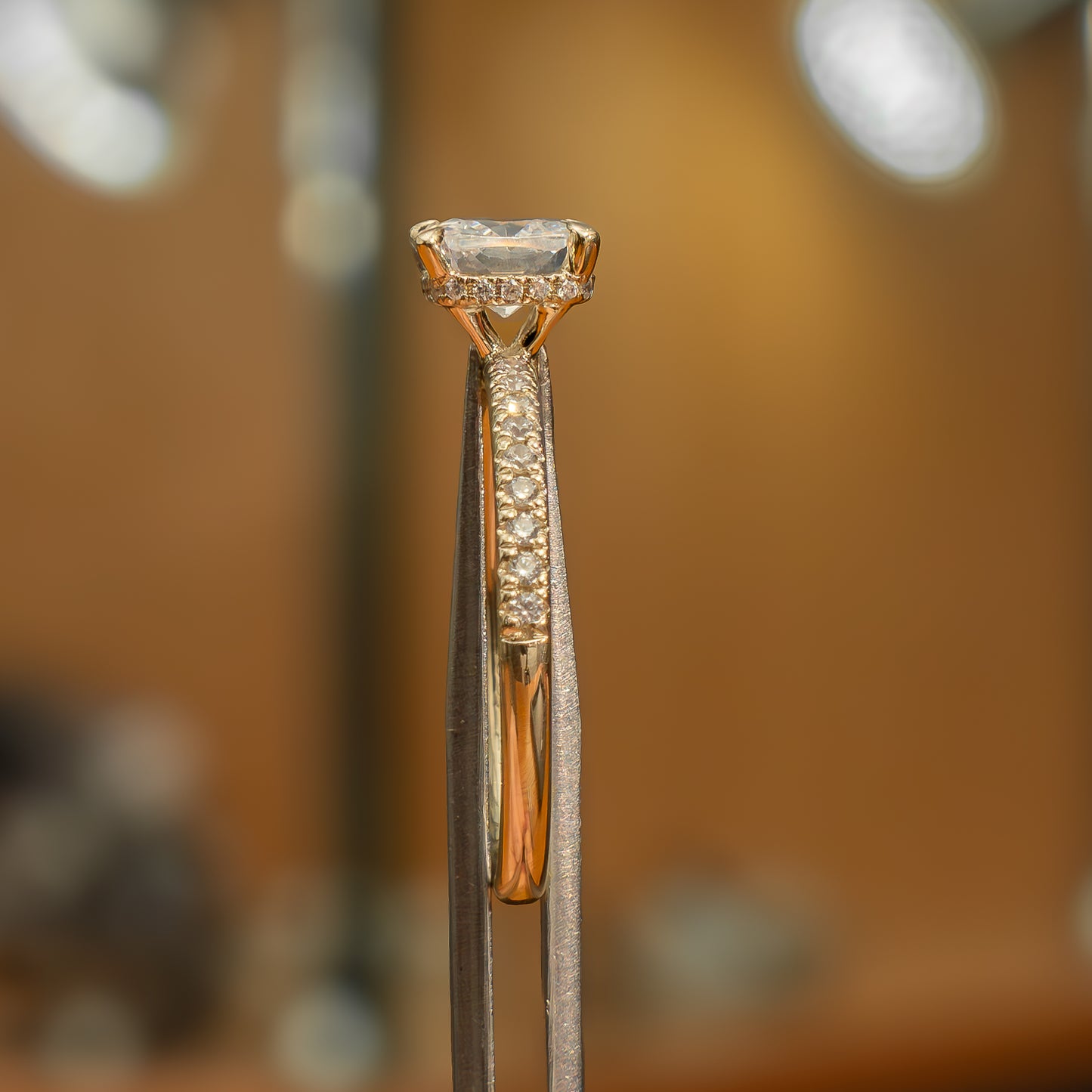 side image of luxury cushion yellow gold diamond set shoulders hidden halo lab grown diamond engagement ring